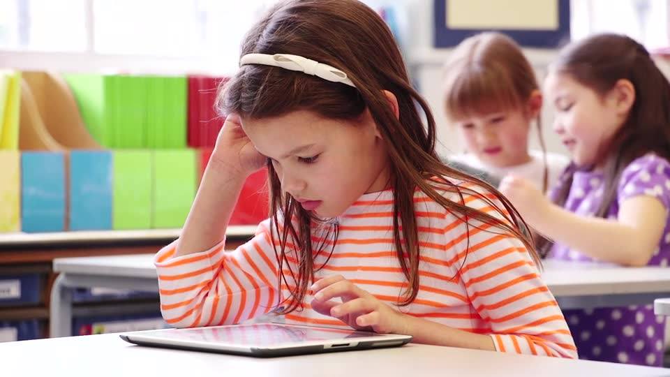 Kid plays on tablet